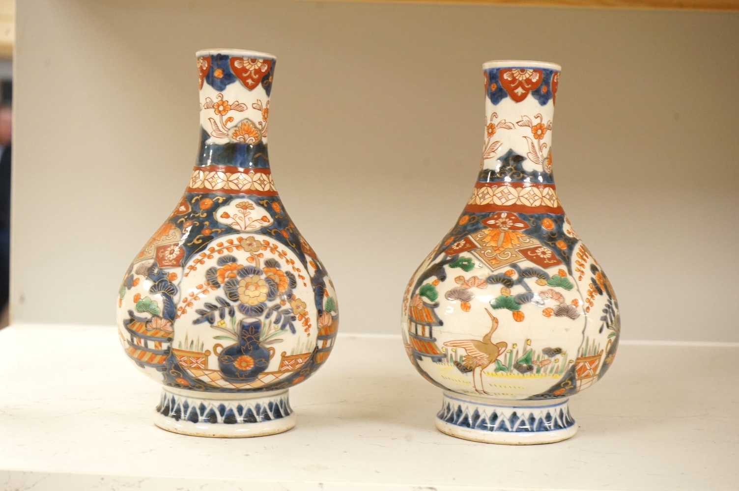 A pair of 19th century Japanese Imari bottle vases, 22cm high